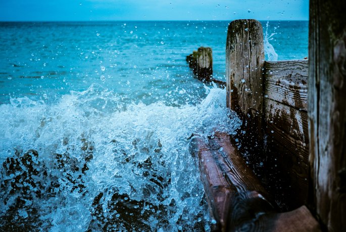 Waves Crashing Against Wood