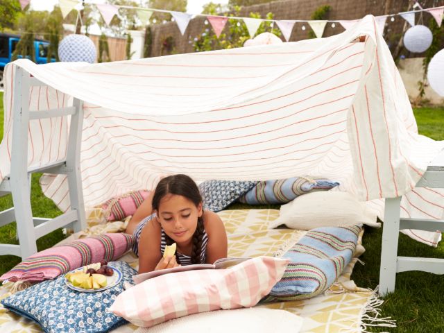 Girl eating fruit in a den