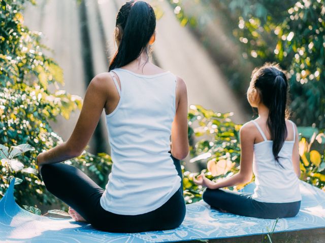 mother and daughter meditating