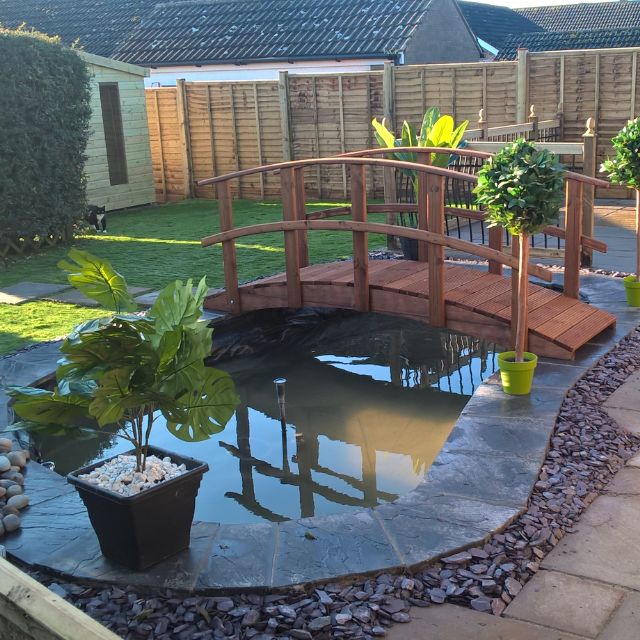 Garden Bridge Over A Pond