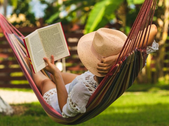 woman reading in a hammock